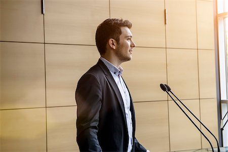 Young businessman speaking in conference Stock Photo - Premium Royalty-Free, Code: 614-07735370