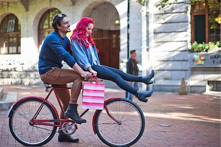 simsearch:6102-08481462,k - Young woman with sitting on boyfriends bicycle handlebars, Cape Town, South Africa Foto de stock - Royalty Free Premium, Número: 614-07735475