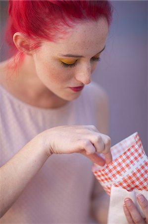 fast food city - Young woman with pink hair eating takeaway food Stock Photo - Premium Royalty-Free, Code: 614-07735478