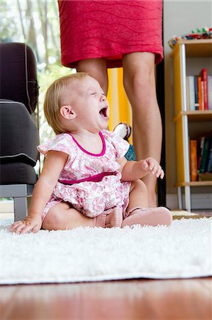 screaming babies - Legs of mid adult mother next to screaming baby daughter Stock Photo - Premium Royalty-Free, Code: 614-07735508