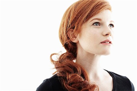 red hair - Studio portrait of young woman gazing upwards Stock Photo - Premium Royalty-Free, Code: 614-07735536