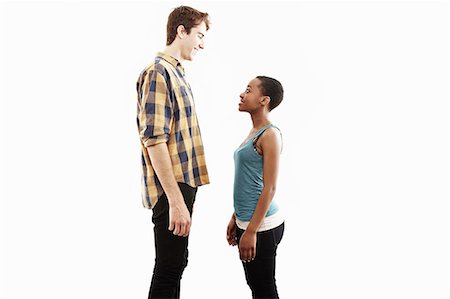 Side view studio portrait showing contrasting height of young couple Foto de stock - Sin royalties Premium, Código: 614-07735572