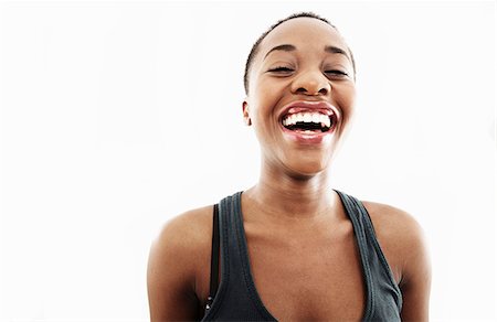 femelle uniquement - Studio portrait of young woman laughing Stock Photo - Premium Royalty-Free, Code: 614-07735586