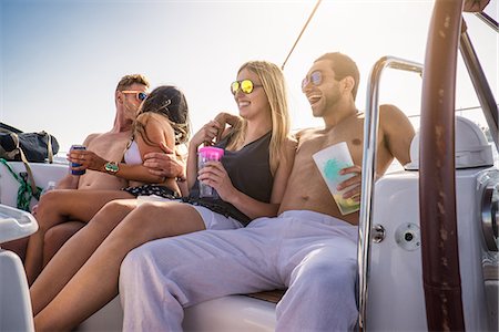 Young people on yacht with drinks, laughing Stock Photo - Premium Royalty-Free, Code: 614-07768057