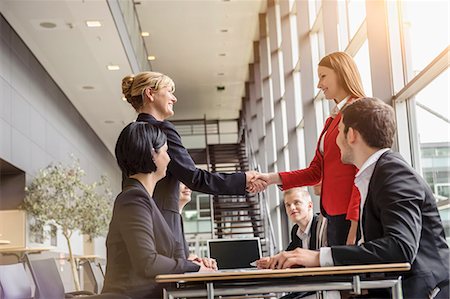 Businesswoman and team meeting client Stock Photo - Premium Royalty-Free, Code: 614-07768128