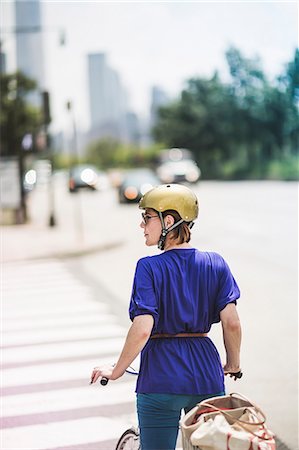 Mid adult woman cyclist waiting at pedestrian crossing, New York City, USA Stock Photo - Premium Royalty-Free, Code: 614-07768223