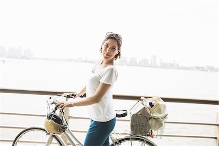 Portrait of mid adult female cyclist at riverside, New York City, USA Stock Photo - Premium Royalty-Free, Code: 614-07768232