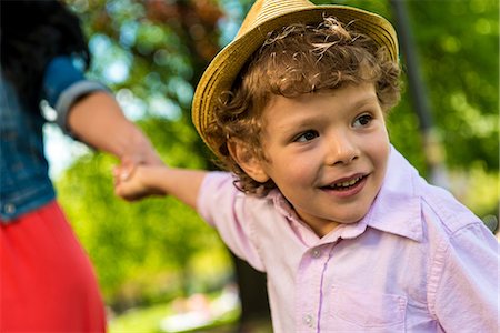 Close up of boy holding mother's hand in park Stock Photo - Premium Royalty-Free, Code: 614-07768243