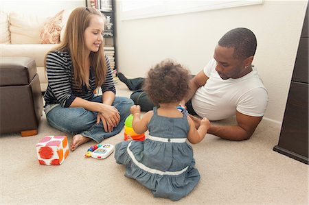 smiling mixed race mother and daughter - Mother and father playing with young daughter Stock Photo - Premium Royalty-Free, Code: 614-07768267