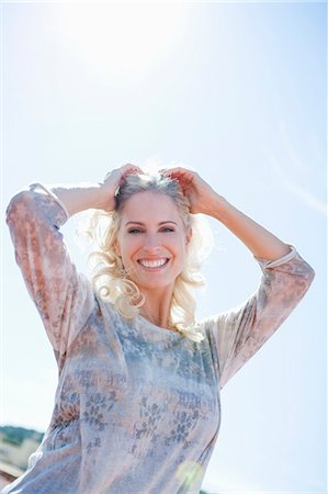 Woman posing against sunny sky Foto de stock - Sin royalties Premium, Código: 614-07805923