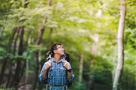 portrait looking away - Hiker with backpack in forest Stock Photo - Premium Royalty-Free, Code: 614-07806039