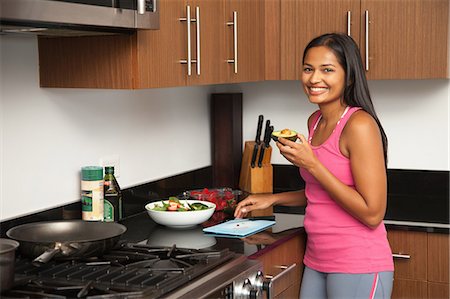 portrait woman cook - Woman preparing salad in kitchen Stock Photo - Premium Royalty-Free, Code: 614-07806263