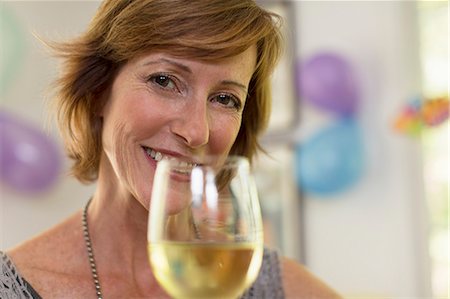 people party home not business - Portrait of mature woman holding glass of wine Stock Photo - Premium Royalty-Free, Code: 614-07806338