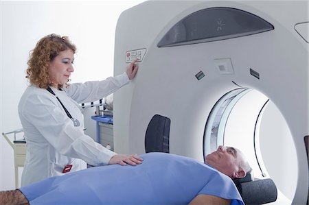 doctor consulting patient with medicine - Doctor preparing patient for CT scanning Stock Photo - Premium Royalty-Free, Code: 614-07806554