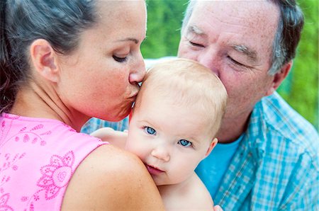 simsearch:400-04612785,k - Close up of mother and grandfather kissing baby girl Stock Photo - Premium Royalty-Free, Code: 614-07911725