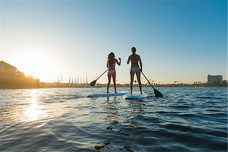 simsearch:614-08270440,k - Rear view of two women stand up paddleboarding, Mission Bay, San Diego, California, USA Stock Photo - Premium Royalty-Free, Code: 614-07911739