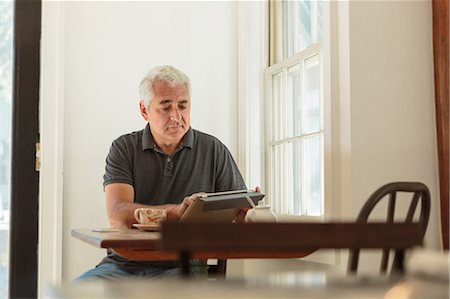 simsearch:614-08030804,k - Mature man using digital tablet in country store cafe Stock Photo - Premium Royalty-Free, Code: 614-07911775