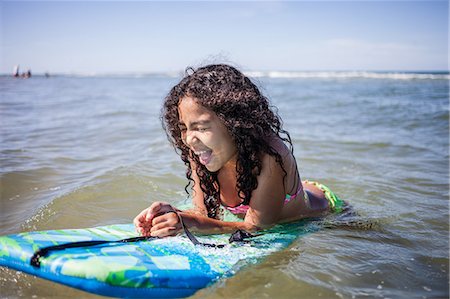 Girl playing on bodyboard, Truro, Massachusetts, Cape Cod, USA Stock Photo - Premium Royalty-Free, Code: 614-07911903