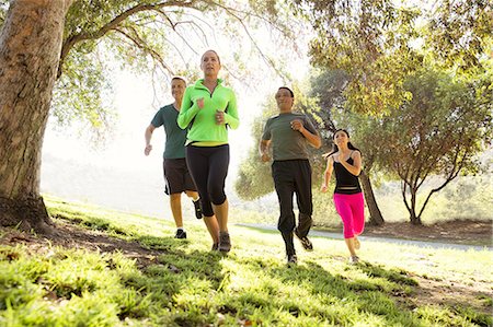 simsearch:640-06050690,k - Four mature men and women running in park Photographie de stock - Premium Libres de Droits, Code: 614-07911952