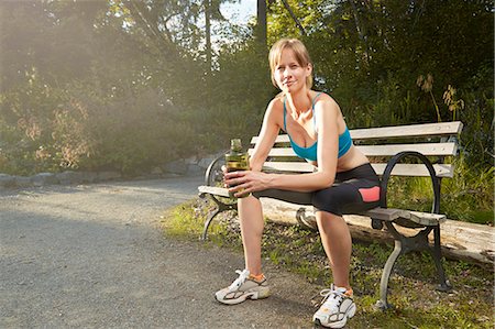 portrait fitness runner - Portrait of smiling female runner taking a break on park bench Stock Photo - Premium Royalty-Free, Code: 614-07911963