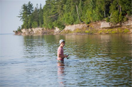 Wading teenage boy fishing in Lake Superior, Au Train Bay, Michigan, USA Stock Photo - Premium Royalty-Free, Code: 614-07912000