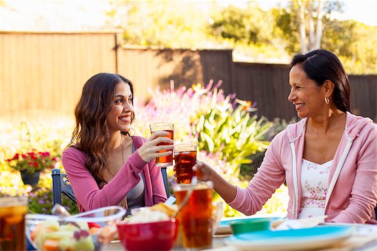 Mother and daughter toasting in garden Stock Photo - Premium Royalty-Free, Image code: 614-08000159