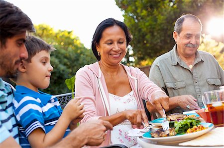 Three generation family dining in garden Stock Photo - Premium Royalty-Free, Code: 614-08000163