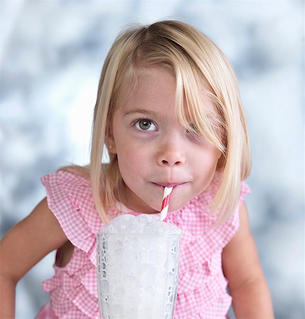 Portrait of cute female toddler blowing bubbles in glass of milk Stock Photo - Premium Royalty-Free, Code: 614-08000177