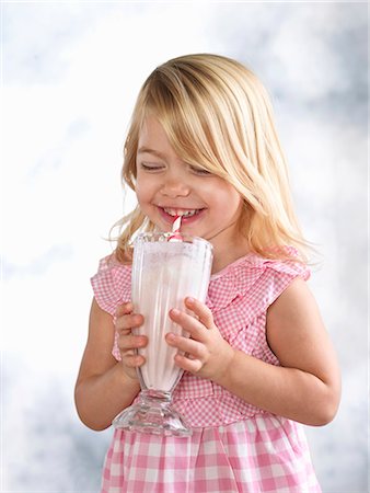 Portrait of giggling female toddler drinking glass of milk Stock Photo - Premium Royalty-Free, Code: 614-08000178