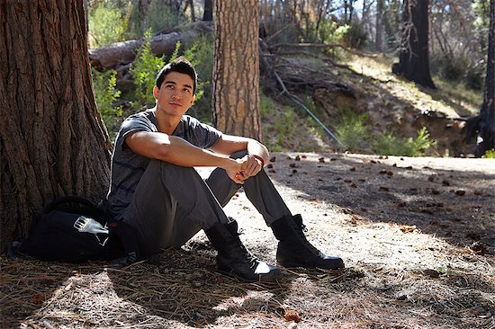Portrait of young man sitting in forest, Los Angeles, California, USA Stock Photo - Premium Royalty-Free, Image code: 614-08000182
