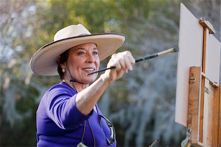 female cowboy hat - Female plein-air painter painting in Albin Polasek Museum and Sculpture Garden, Winter Park, Florida, USA Stock Photo - Premium Royalty-Free, Code: 614-08000220