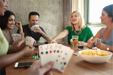 simsearch:614-08000236,k - Group of friends playing cards around table Stock Photo - Premium Royalty-Free, Code: 614-08000243