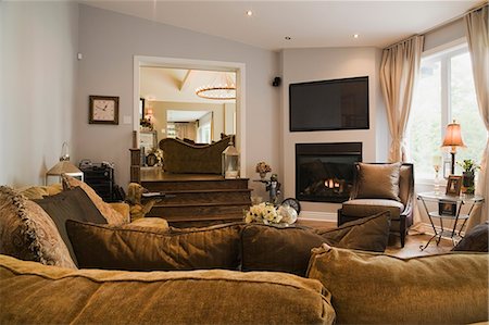 Living room with fireplace and L-shaped sofa in luxury home Stock Photo - Premium Royalty-Free, Code: 614-08000277