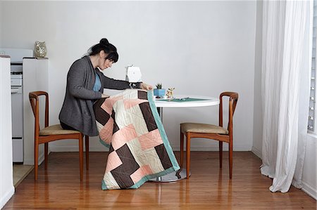 sewing machine woman - Woman making quilt on sewing machine at home Stock Photo - Premium Royalty-Free, Code: 614-08000271