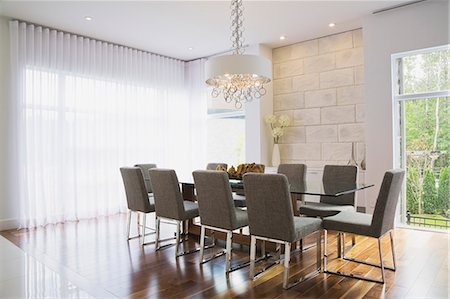 simsearch:614-08881121,k - Modern interior design luxury dining room with glass dining table and grey upholstered dining chairs Stock Photo - Premium Royalty-Free, Code: 614-08000335