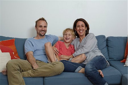 simsearch:614-06896515,k - Parents with son sitting on sofa Stock Photo - Premium Royalty-Free, Code: 614-08000358