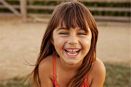 person portrait - Portrait of laughing girl in farmyard Stock Photo - Premium Royalty-Free, Code: 614-08000405