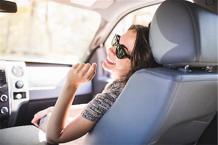Young woman laughing in front seat of car Stockbilder - Premium RF Lizenzfrei, Bildnummer: 614-08030479