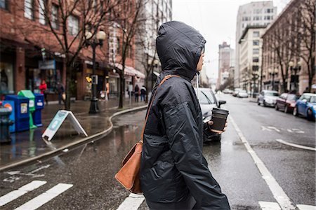 Young woman on rainy pedestrian crossing, Seattle, Washington State, USA Stock Photo - Premium Royalty-Free, Code: 614-08030552