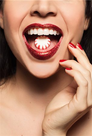 female mouth close up - Mid adult woman with sweet on tongue Stock Photo - Premium Royalty-Free, Code: 614-08030697