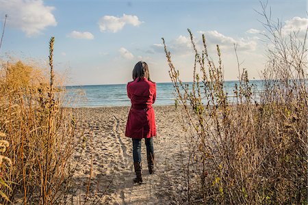 standing back woman - Mid adult woman standing on beach Stock Photo - Premium Royalty-Free, Code: 614-08030741