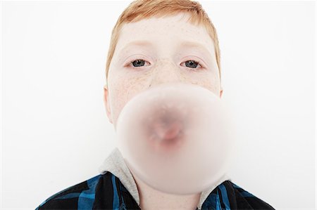 Boy blowing bubble gum Stock Photo - Premium Royalty-Free, Code: 614-08030836