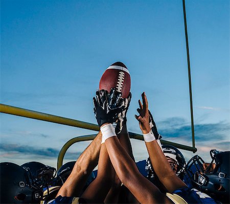 six - Victorious teenage and young male american football team holding up ball Stock Photo - Premium Royalty-Free, Code: 614-08030967