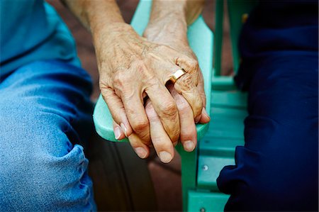 detail - Cropped close up of senior couple hands holding on park bench Stock Photo - Premium Royalty-Free, Code: 614-08031084