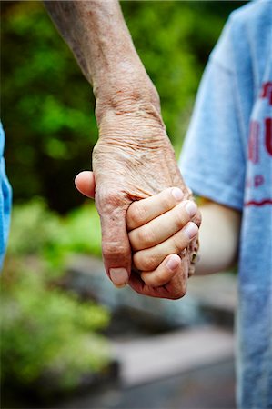 family holding hands - Cropped close up of senior woman and grandson hands holding in park Stock Photo - Premium Royalty-Free, Code: 614-08031085