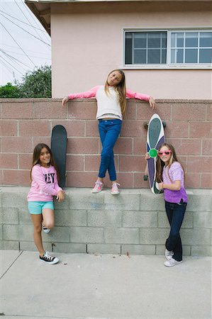 Three girls by wall with skateboards Stock Photo - Premium Royalty-Free, Code: 614-08031144