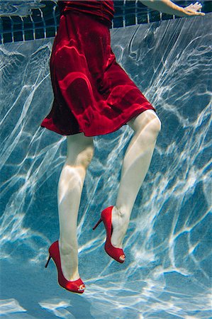 simsearch:614-08220033,k - Mature woman wearing red dress and high heels, underwater view, low section Stock Photo - Premium Royalty-Free, Code: 614-08065885