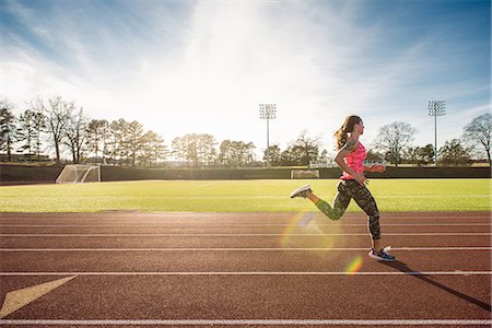 running - Young female athlete running on race track Stock Photo - Premium Royalty-Free, Code: 614-08065914