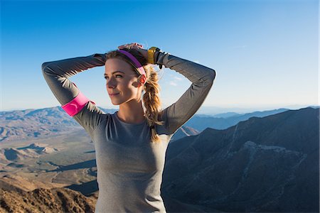 Young female trail runner warming up with hands on head on Pacific Crest Trail, Pine Valley, California, USA Stock Photo - Premium Royalty-Free, Code: 614-08066008