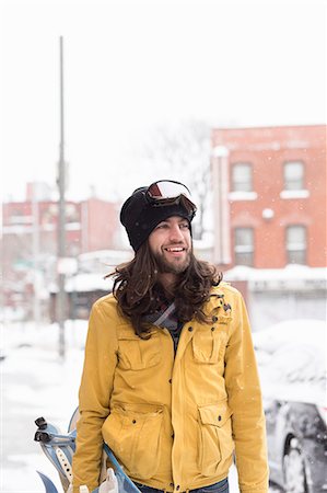 simsearch:614-08081431,k - Smiling male snowboarder in snow covered street Stock Photo - Premium Royalty-Free, Code: 614-08066022